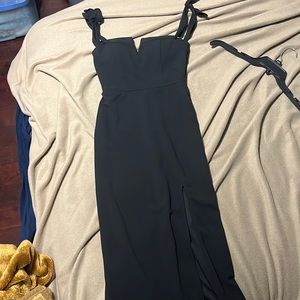 Long black dress with a slit in the left leg.